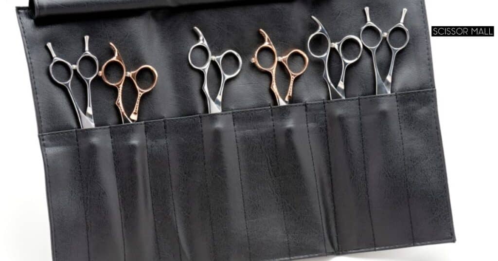 Professional hair cutting scissors and shears side by side on a salon counter