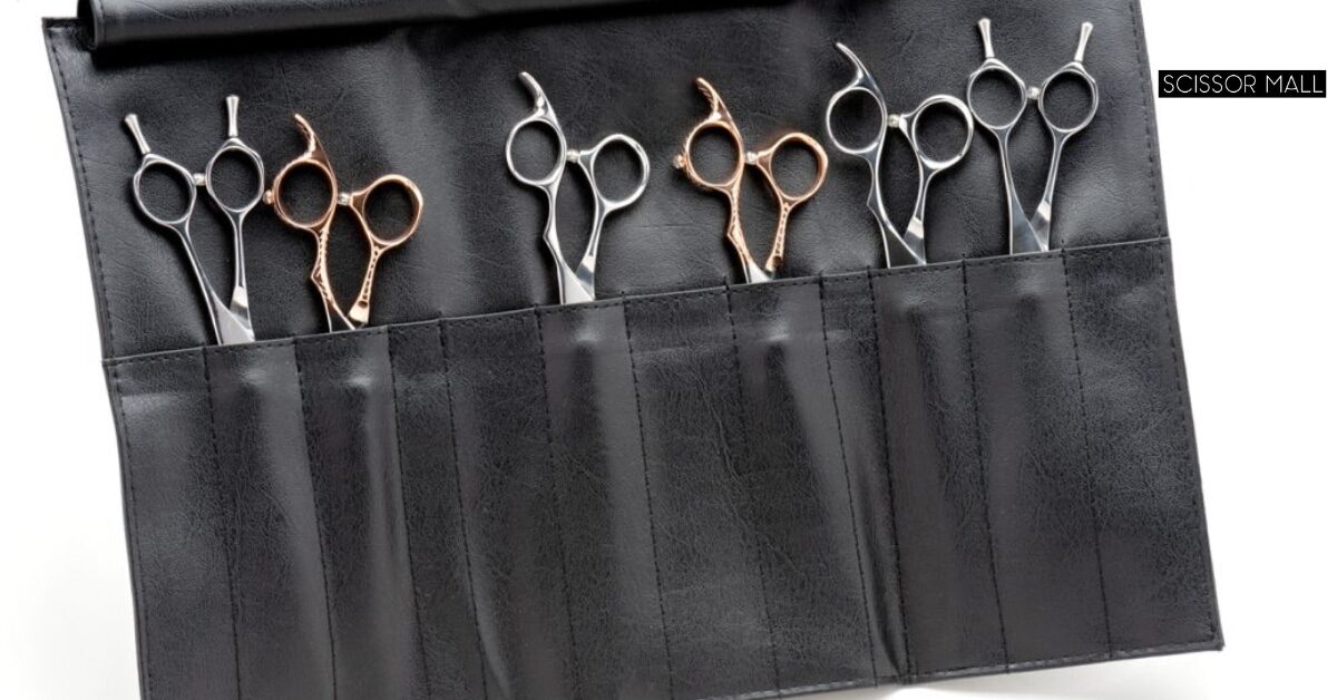 Professional hair cutting scissors and shears side by side on a salon counter