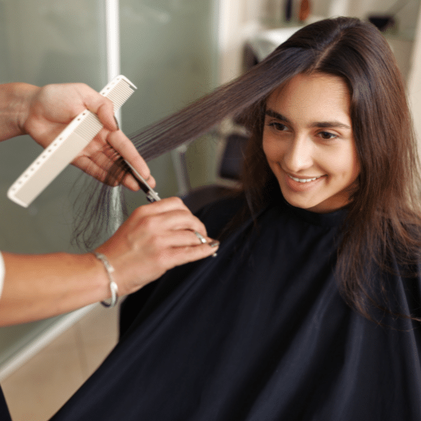 Stylist using small precision scissors to trim bangs